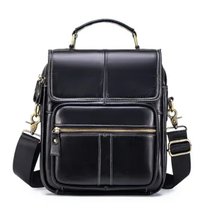 Black leather shoulder bag detail, vertical design with metal hardware and zipper pocket.