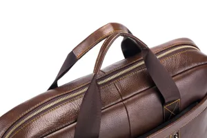Detailed view of brown genuine cowhide leather business briefcase with zipper and handles.