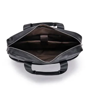 Detailed interior view of black leather business briefcase showing laptop compartment and pockets.