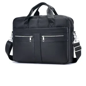 Detailed view of black genuine leather business briefcase, metal zippers, shoulder strap.