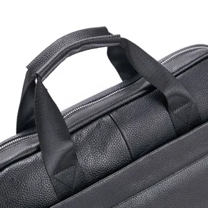 Detail shot of black leather briefcase handle and zipper, premium business laptop bag close-up.
