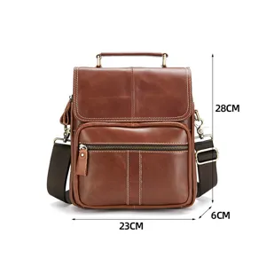 Detailed view of the brown leather mens messenger bag, showing front pocket and metal hardware.