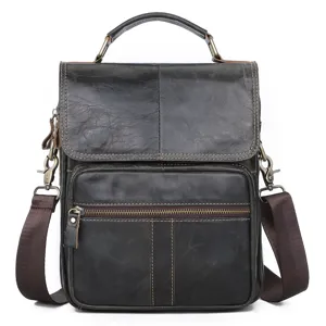 Detailed view of genuine leather mens messenger bag with top handle and front pocket.