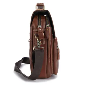 Side detail view of brown genuine cowhide leather men messenger bag with metal zippers.