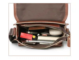 Vintage leather messenger bag interior detail showing spacious multi-pocket storage.