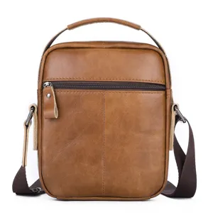 Men brown leather shoulder bag detail shot, vintage crossbody bag with top handle and zippers.