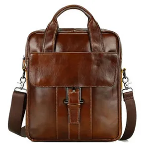 Leather business briefcase detail showing fine texture, sturdy handles and metallic buckle lock.