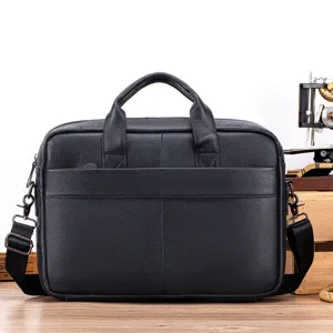 Detail view of black leather men business briefcase, soft cowhide texture and metal hardware.