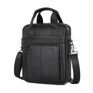 Detail view of men's genuine leather briefcase, black shoulder bag and stylish business handbag.