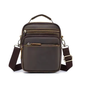 Detailed view of vintage leather crossbody bag, brown cowhide messenger bag with zippers.