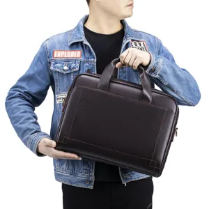 Detailed view of brown genuine leather men business briefcase with sturdy handles and hardware.