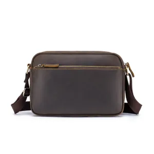 Detailed close-up of retro brown crazy horse leather bag featuring fine stitching and metal zip.
