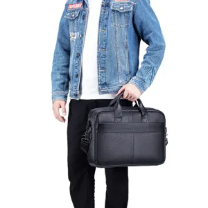 Detail view of men's leather briefcase, showing premium soft cowhide texture and handles.