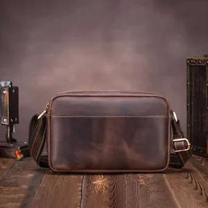 Detailed view of vintage crazy horse leather men's messenger bag with durable metal hardware.
