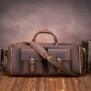 Vintage leather travel duffle bag detail view, durable zippers and practical front pockets.