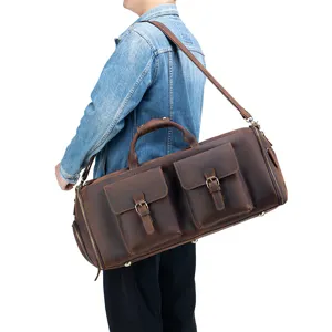 Genuine leather travel duffel bag with front pockets and shoulder strap, detail view.