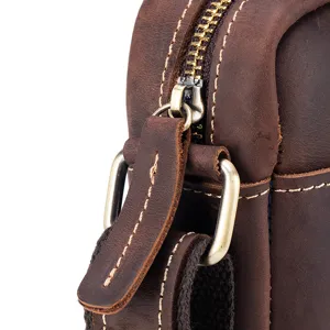 Close up detail of vintage crazy horse leather bag zipper and metal hardware craftsmanship.
