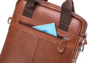 Detail view of brown genuine leather men business briefcase featuring zipper pocket and handles.