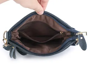 Leather shoulder bag inner lining detail view showcasing brown fabric and zipper pocket structure.
