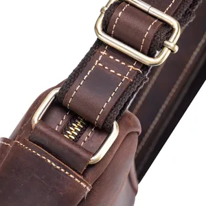 Close-up detail of retro crazy horse leather bag hardware, heavy stitching, and metal buckle.