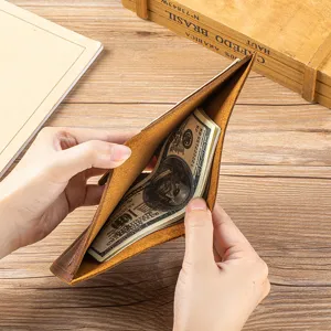Close-up detail view of the vintage brown crazy horse leather wallet interior and cash storage.