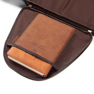 Brown travel garment bag interior detail with mesh storage pocket and compact notebook organizer.