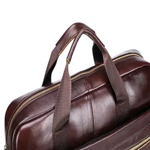 Leather briefcase handle and zipper detail, genuine cowhide business bag close-up view.