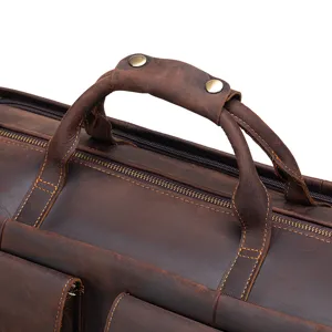 Genuine leather travel bag handle detail, durable brown duffel luggage and suit storage.