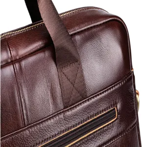 Close-up detail of dark brown genuine leather men business briefcase texture and zipper.