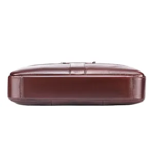 Brown leather briefcase bottom detail showing fine cowhide grain and durable stitching work.