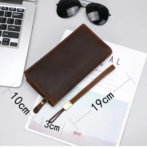 Detailed view of genuine leather long wallet with wrist strap, showing compact size.