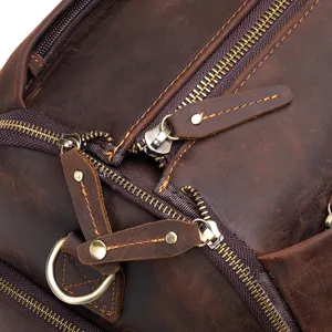 Detailed close-up of vintage brown genuine leather travel bag with durable metal zippers.