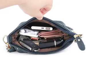 Detailed view of genuine leather shoulder bag interior capacity, showing spacious storage and lining.