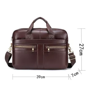 Detailed view of brown leather business briefcase with dual front zipper pockets and shoulder strap.