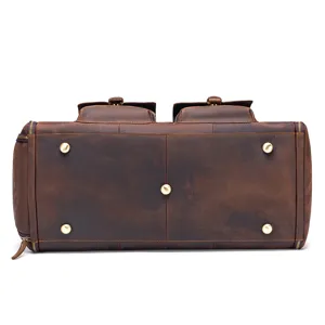 Genuine leather travel duffel bag bottom view with metal feet and durable zipper closure.