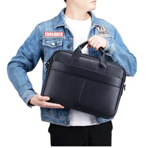 Detailed view of black genuine leather business laptop briefcase, premium soft texture.