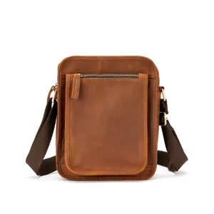 Detailed view of genuine leather messenger bag with front zip pocket and sturdy strap.