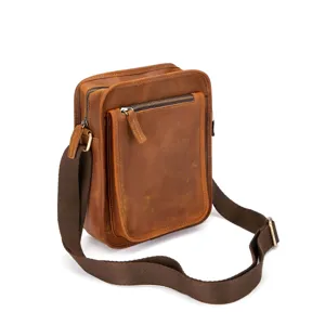 Detailed view of the brown leather vintage messenger bag with metal zipper and strap.