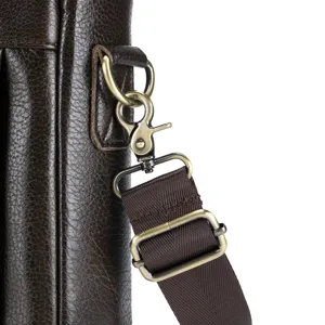 Close-up detail of mens brown leather shoulder bag strap hardware and durable metal clasps.