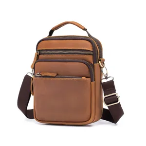 Close-up detail of vintage brown crazy horse leather men messenger bag with multi zipper pockets.