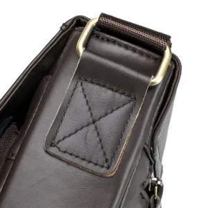 Close-up detail of genuine leather men's messenger bag strap connection and buckle.