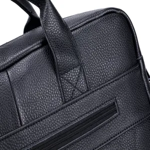 Black genuine leather briefcase detail showing premium texture and reinforced stitching.