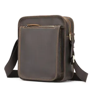 Detailed view of the vintage crazy horse leather men's vertical shoulder cross body bag.