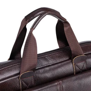 Brown leather briefcase handle detail close-up showing fine stitching and durable material.