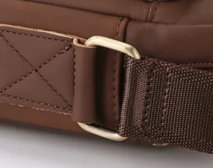 Close-up detail of genuine leather men bag strap buckle, high quality hardware and stitching.