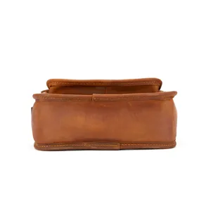 Close-up detail of brown genuine crazy horse leather bag bottom with neat stitching.