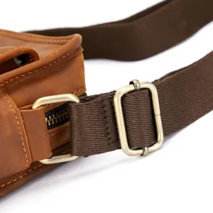 Detailed shot of men leather shoulder bag strap buckle, vintage hardware craft and texture.