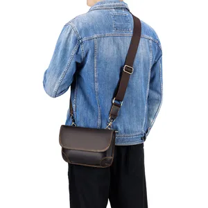 Men's brown leather crossbody shoulder bag detailed view with adjustable strap and buckle.