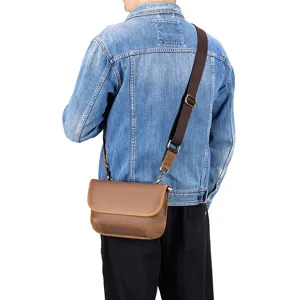 Men's brown leather crossbody shoulder bag worn on back, detailed view showcasing casual design.