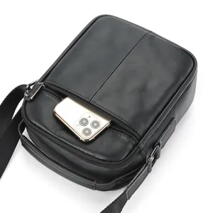 Detailed view of black genuine leather men's messenger bag with front zip pocket.